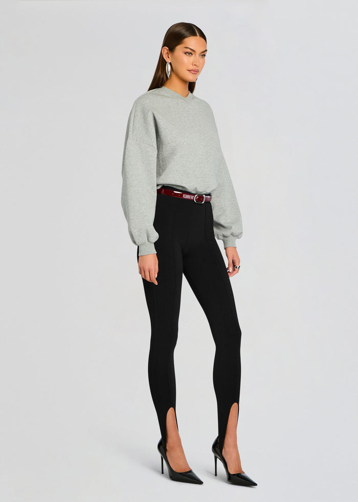 Grey Taley Sweatshirt with oversized sleeves paired with black high-waisted pants featuring ankle slits and a burgundy belt media 3 of 5
