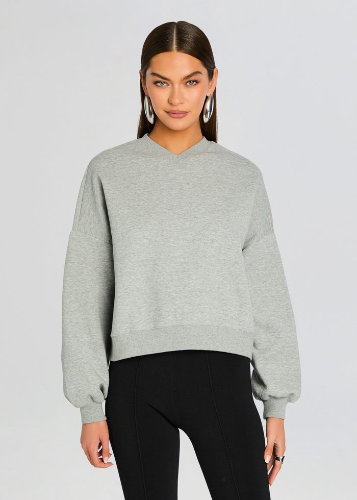 Model wearing light gray Taley Sweatshirt with a relaxed fit and oversized sleeves and a ribbed hem media 1 of 5