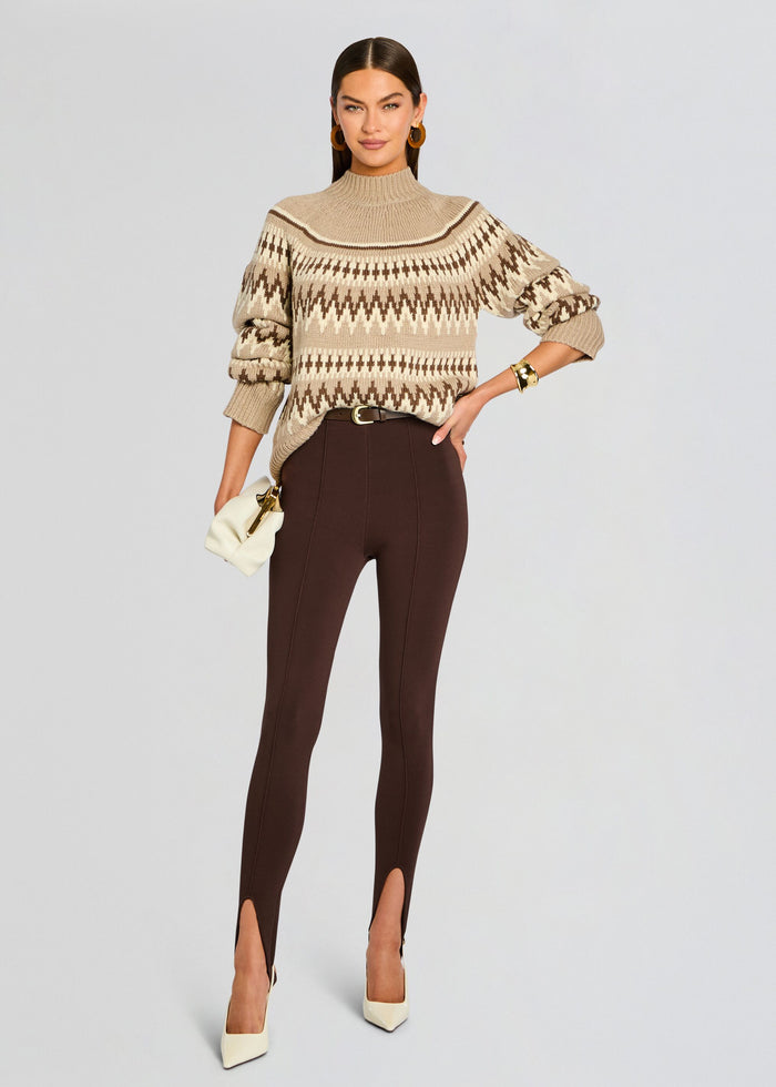 Model wearing Tirza Sweater in beige and brown fair isle knit tucked into dark brown pants with a cream handbag media 2 of 5