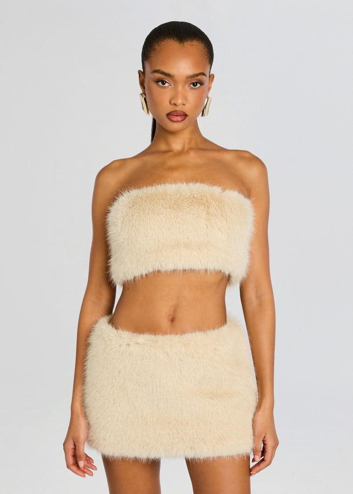 Cream faux fur bandeau top with a matching mini skirt worn by a model, front view. media 1 of 7