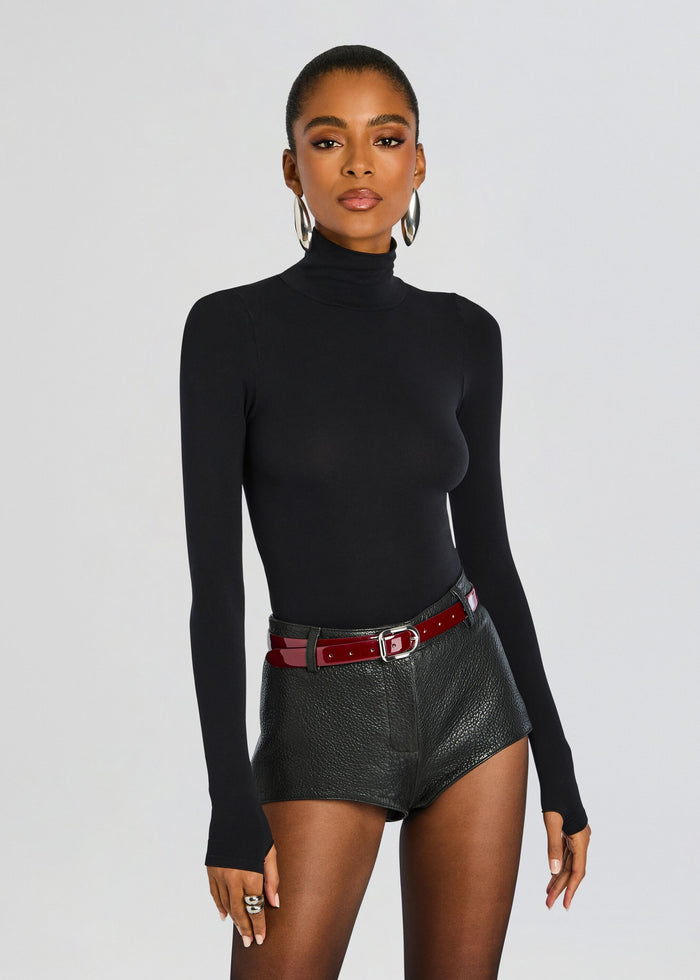 Front view of a model in a black ballet turtleneck bodysuit. media 1 of 6
