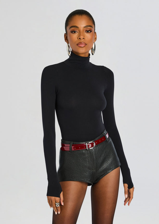 Front view of a model in a black ballet turtleneck bodysuit.