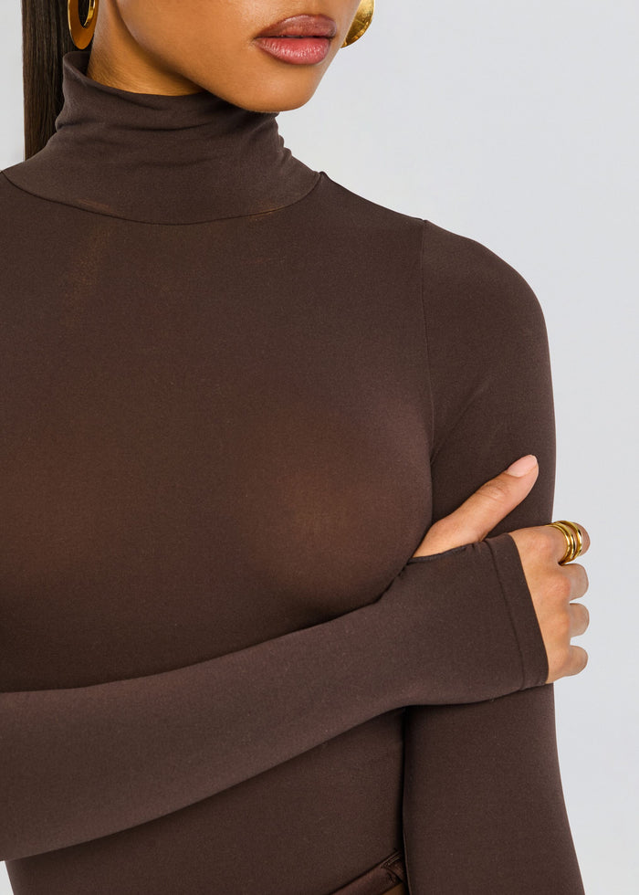Close-up of chocolate brown Ballet Turtleneck Bodysuit highlighting the turtleneck and smooth fabric. media 2 of 6