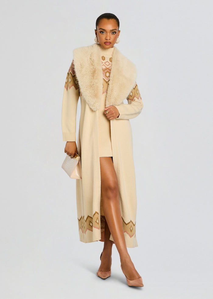 Model in cream Basalt Knit Cardigan with a geometric patterned top underneath, plus nude heels and a small beige handbag. media 1 of 6