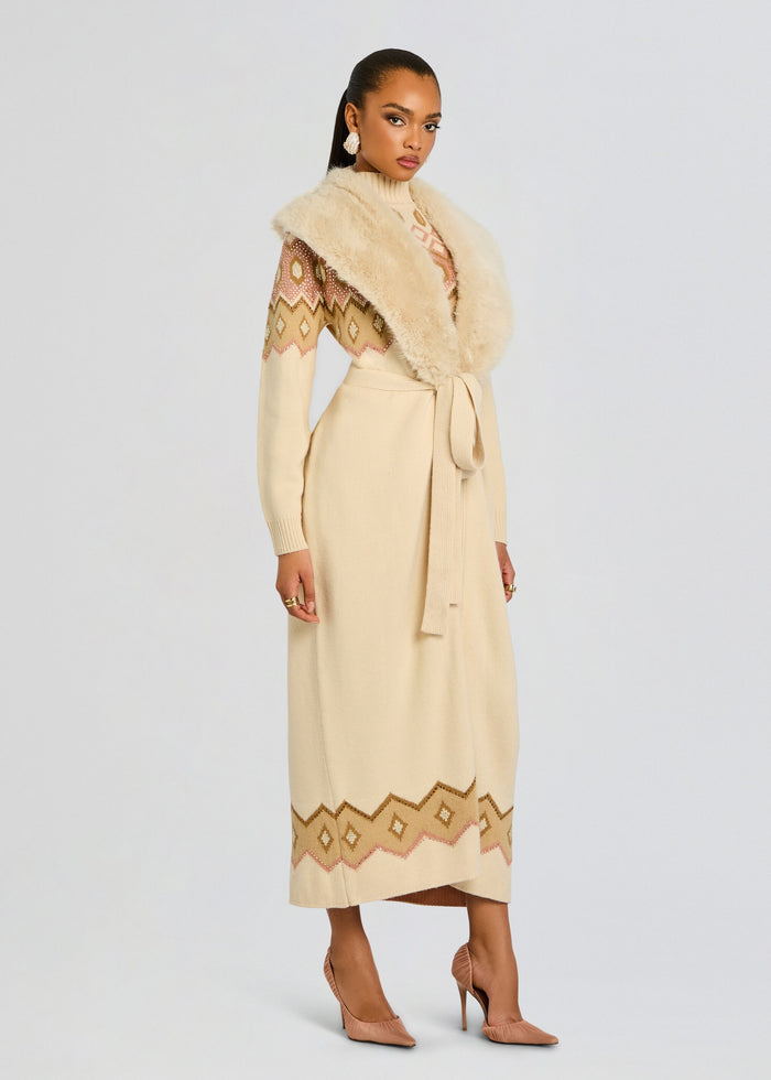 Side view of model in cream Basalt Knit Cardigan with fur stole and geometric border at hem media 4 of 6