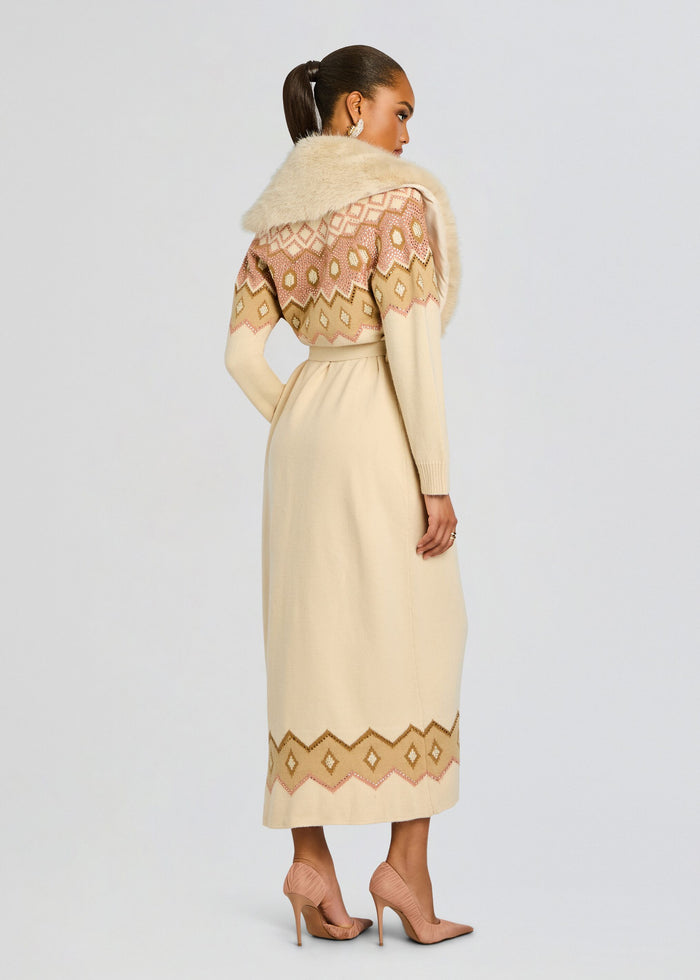Back view of Basalt Knit Cardigan belted at the waist with a geometric pink beige pattern and a plush fur collar. media 5 of 6
