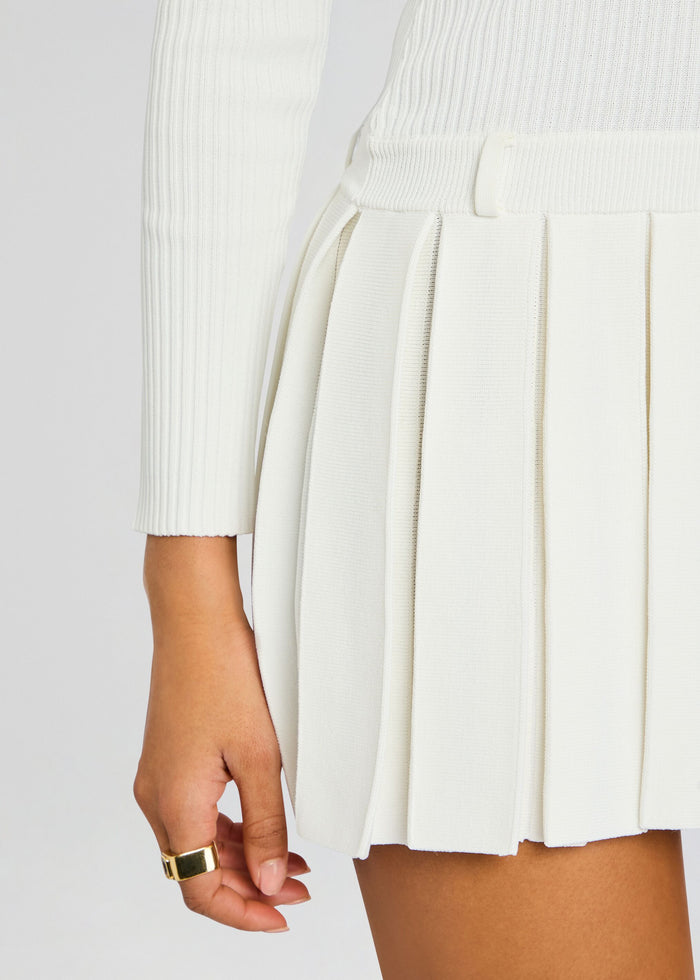 Close up of the Devika Knit Dress waist showing a slim waistband and crisp vertical pleats. media 2 of 5