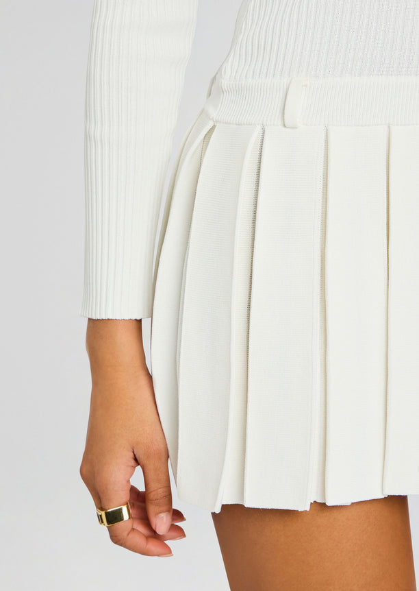 Close up of the Devika Knit Dress waist showing a slim waistband and crisp vertical pleats.