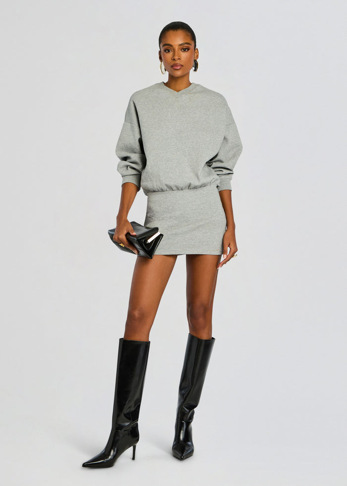 Dionne Mini Dress in heather gray with a cinched waist, paired with black knee high boots and a black clutch media 5 of 5