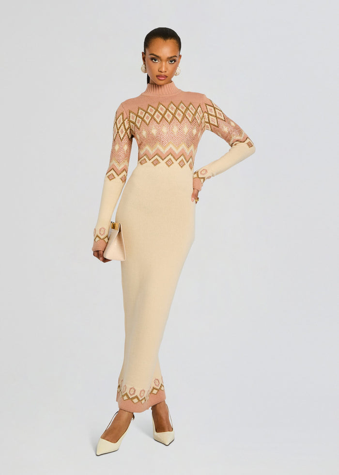 Model in a pink and cream Eagle Knit Dress with diamond pattern and turtleneck, holding a beige clutch media 1 of 7