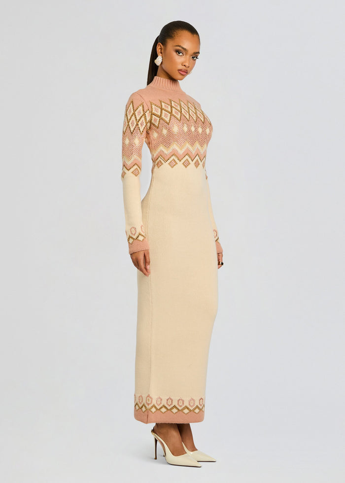 Full-length side view of a model wearing the Eagle Knit Dress in pink and cream with a ribbed turtleneck and sequined geometric pattern media 4 of 7