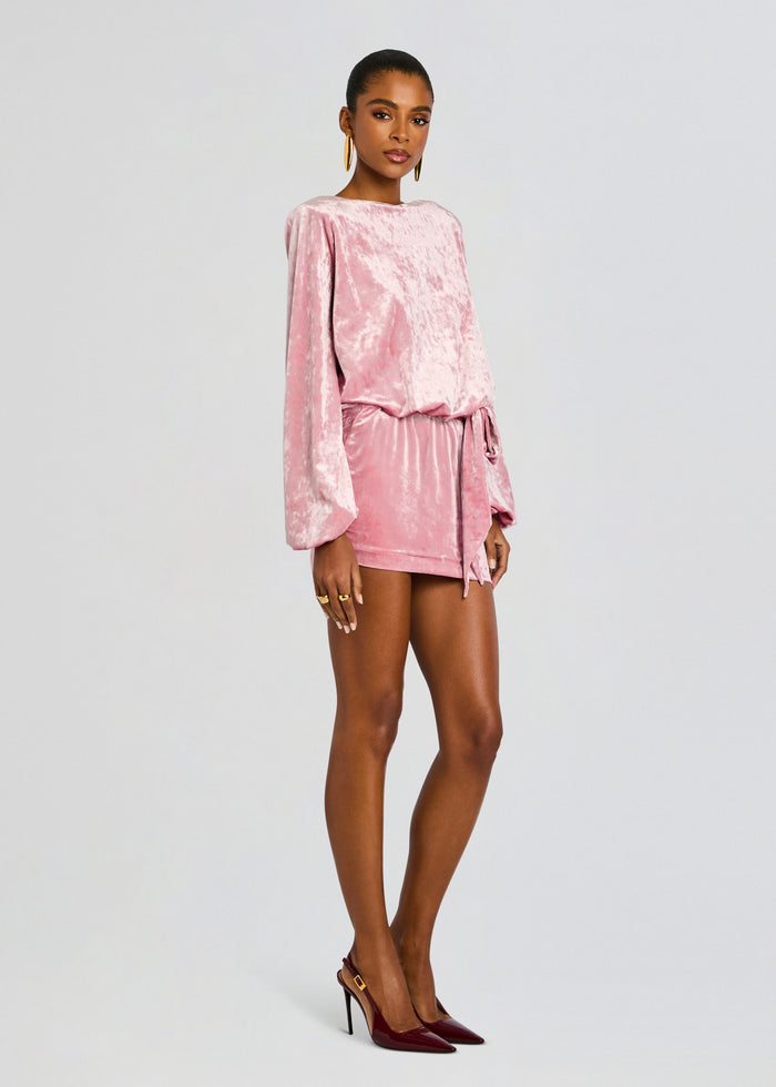 Model wearing pink crushed velvet Elysia Dress with long bishop sleeves and a waist tie media 3 of 5