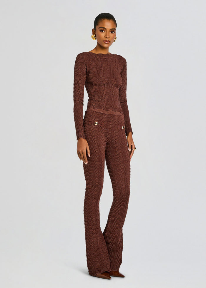 Full-length model wearing a brown Joliet rib knit set with a fitted top and wide-leg pants with gold button pockets. media 4 of 5