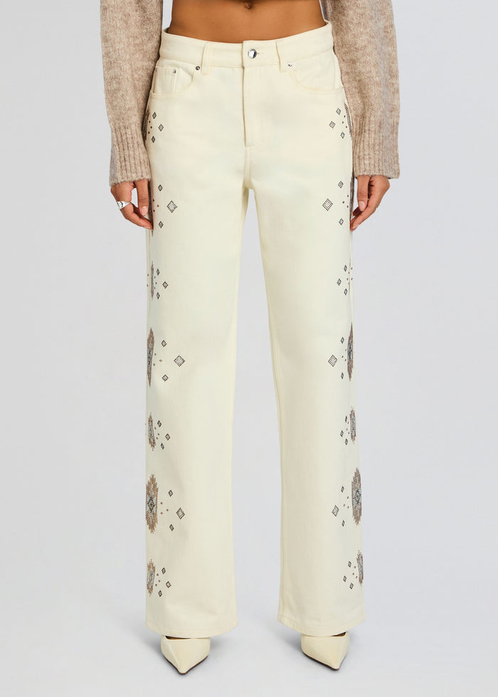 Front view of pale cream high-waisted jeans with scattered diamond embroidery along the legs. media 6 of 6