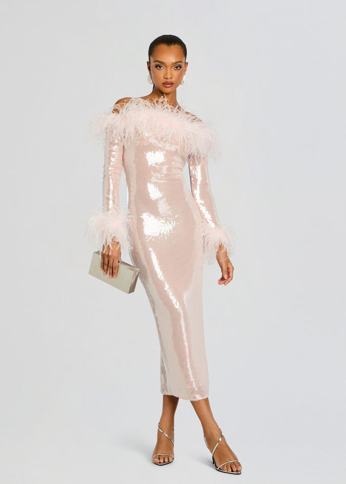 Model wearing Petal Sequin Midi Dress in pale pink with feather trimmed shoulders and cuffs, holding a beige clutch. media 1 of 6