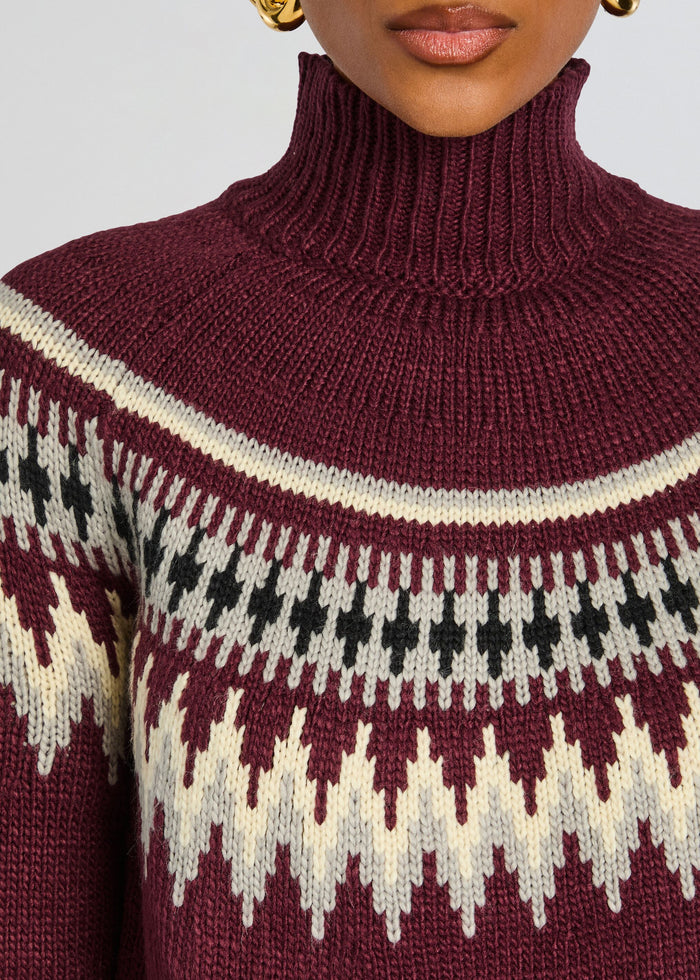 Close up of burgundy knit turtleneck with ribbed collar and cream black geometric yoke pattern media 2 of 5