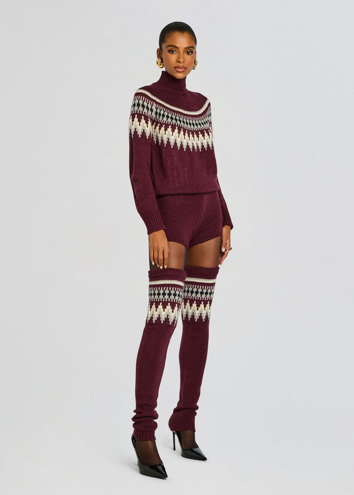 Model wearing burgundy Rocky Knit Romper with a patterned yoke sweater and matching knit thigh high socks. media 3 of 5