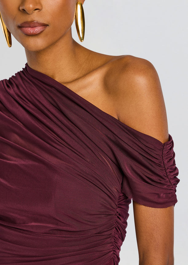 Close-up of burgundy Selma Mini Crepe Dress highlighting ruched fabric and off-shoulder neckline.