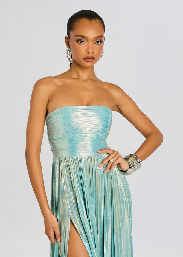 Front view of Sevyn Dress with a strapless metallic teal bodice and pleated skirt, styled with statement earrings.