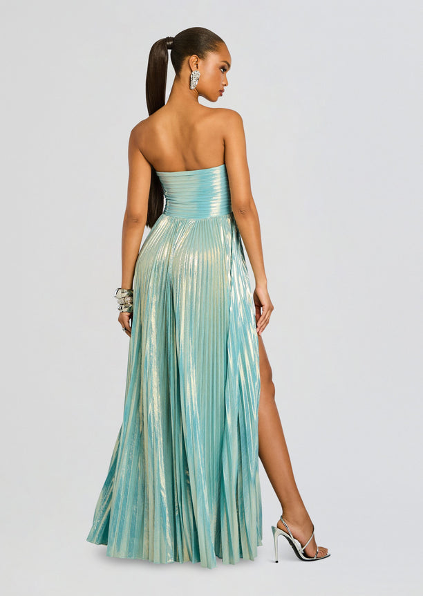 Back view of Sevyn Dress in metallic teal with a strapless ruched bodice and full pleated skirt with a side slit.