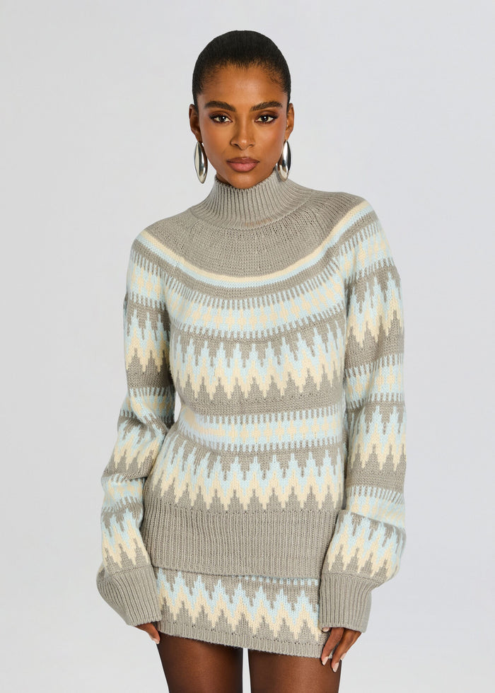 Front view of a model in a beige gray Tirza Sweater with pale blue zigzag stripes and a ribbed turtleneck media 1 of 5