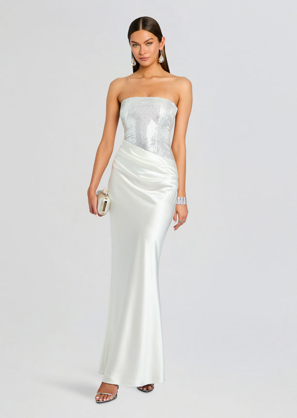 Alexandra Embellished Dress worn by a model featuring a silver sequined strapless bodice and a satin skirt.