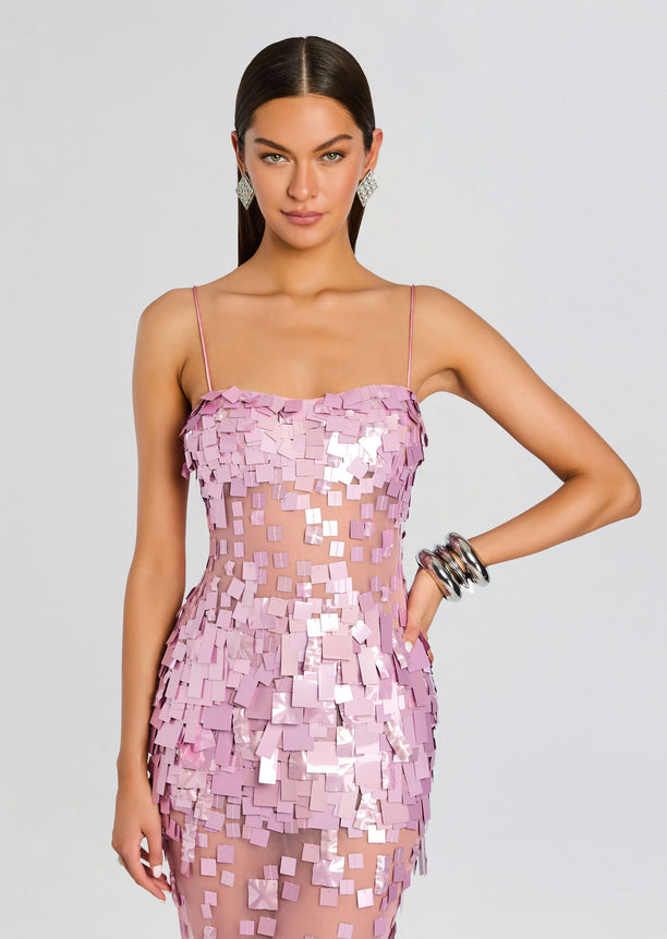 Model wearing Carmin Embellished Dress in pink with square sequins and a sheer midsection panel.