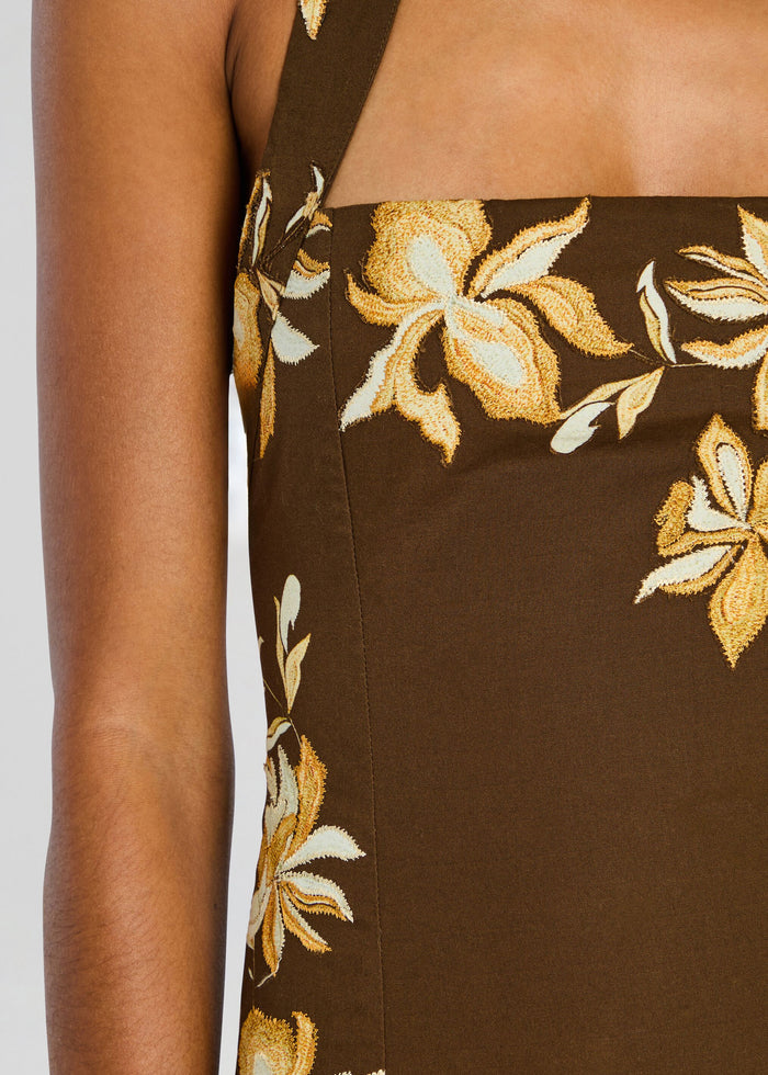 Close-up of brown halter dress bodice with yellow floral embroidery around the neckline. media 2 of 5