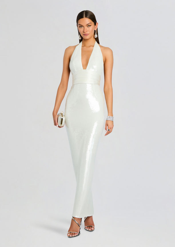 Model wearing mint Kelsie Sequin Dress with halter neck deep V neckline and wide satin waist band