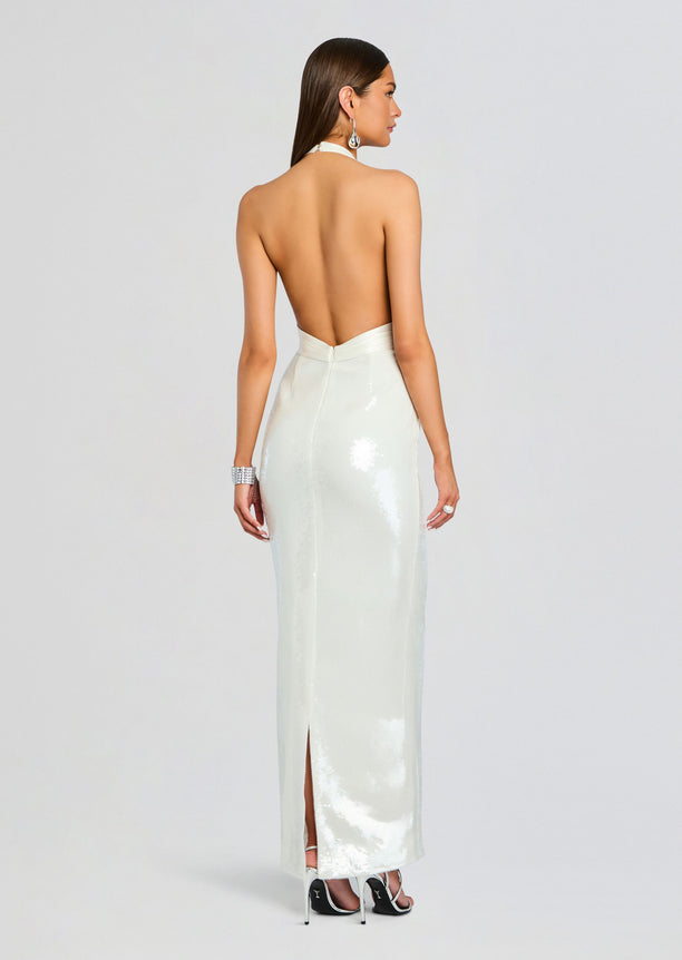 Back view of a white sequin Kelsie dress with halter neckline and back slit