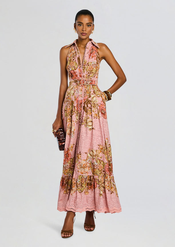 Model wearing a pink floral Sula Long Shirt Dress with a buckle belt and halter neckline.