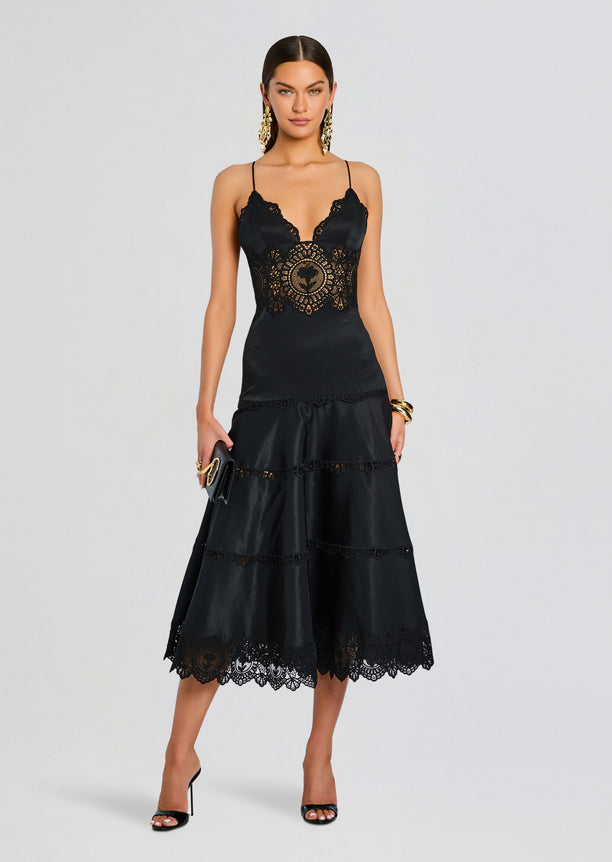 Black lace slip dress with halter straps and intricate cutout lace in a midi length.