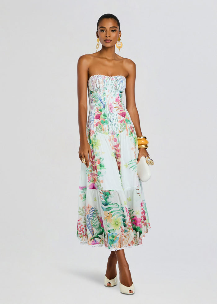 Model in a strapless Illyr Long Dress with a tropical floral print and lace trim at the hem. media 1 of 5