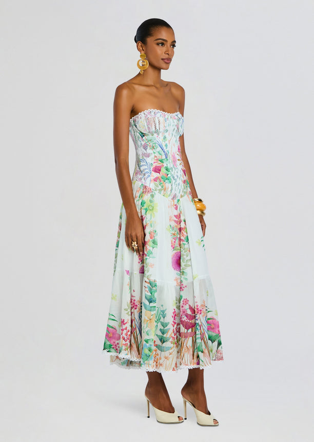 Illyr Long Dress strapless floral maxi worn by a model with scalloped lace trim at the bust.