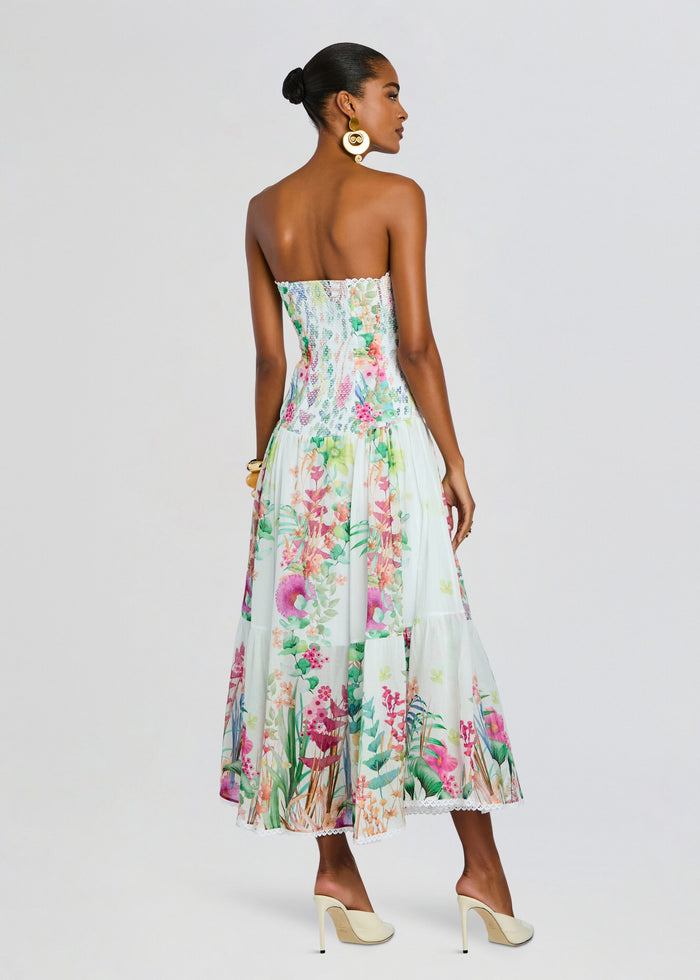 Back view of Illyr Long Dress showing a smocked bodice and flowing pastel floral skirt. media 4 of 5