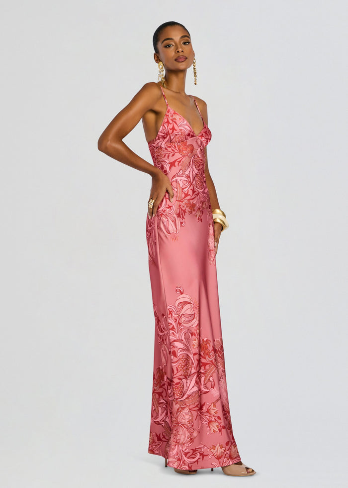 Model wearing pink Vine Maxi Dress with a vivid floral pattern and thin spaghetti straps. media 3 of 5