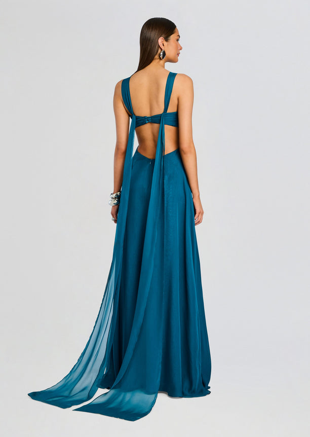 Back view of teal Meira chiffon dress with open back and long draped panels.