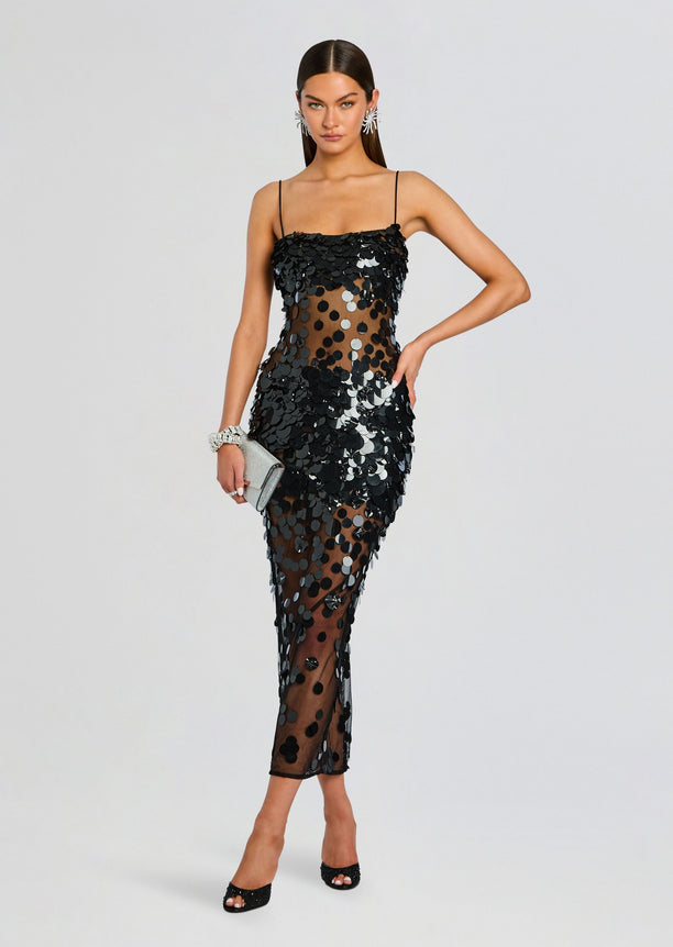 Mischa Sequin Dress worn by a model, black sequins cover a sheer mesh midi dress.