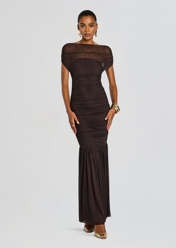 Full-length Noel Gown in dark brown with ruched bodice, sheer off‑the‑shoulder neckline, and a sheer hem panel.
