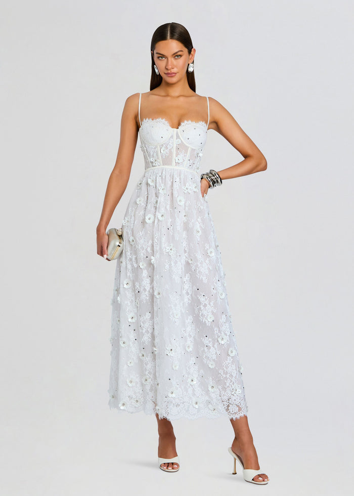 Model in Noema embellished lace dress with sheer bodice and delicate floral embroidery media 1 of 5