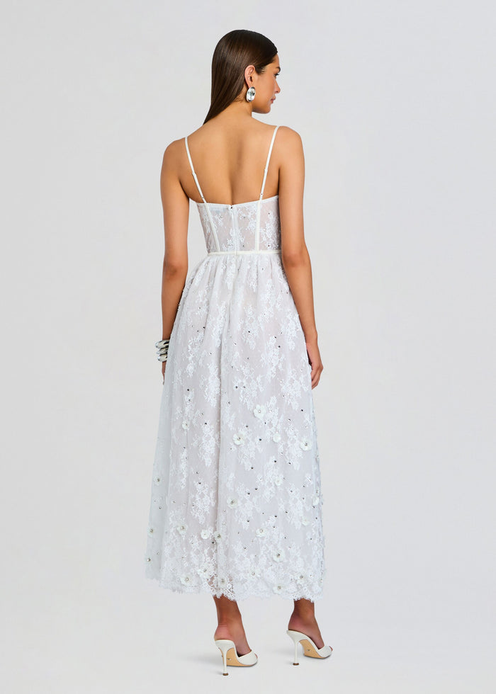 Back view of the Noema Embellished Lace Dress showing sheer panels, slim straps, and floral appliqués along the skirt. media 4 of 5