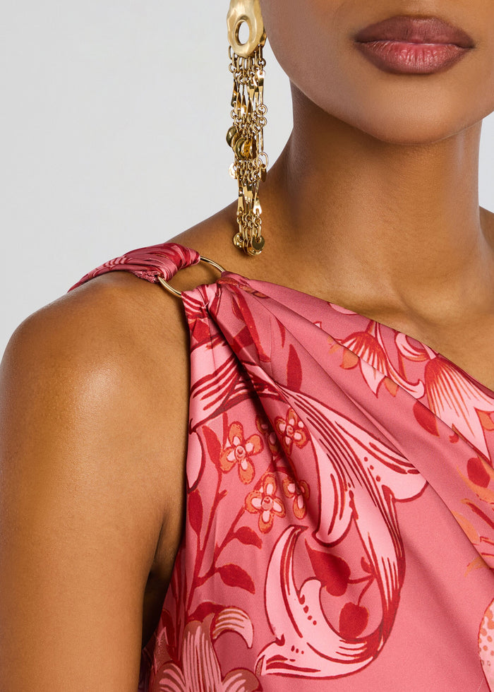 Close up of a pink floral Vine One Shoulder Sash Dress with a wrapped shoulder strap and a gold dangling earring media 2 of 5
