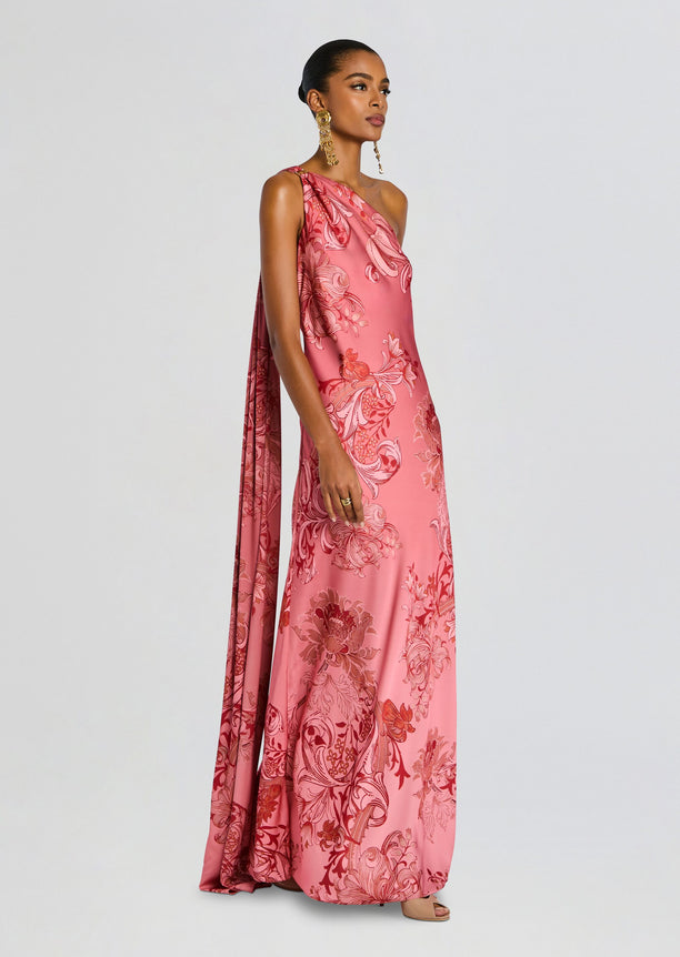 Side view of a model in a pink floral Vine One Shoulder Sash Dress showing the one shoulder silhouette and flowing sash