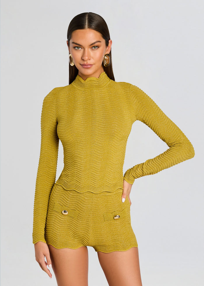 Model wearing mustard Prissy Knit Top with matching textured shorts and gold buttons. media 1 of 6