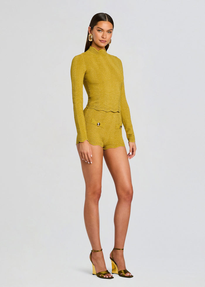 Model wearing mustard Kait Knit Short set with textured long sleeve top and scalloped hem shorts with gold accessories media 4 of 6