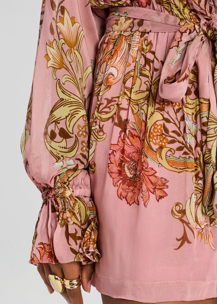 Close up on the waist area of the pink floral romper, showcasing the tie belt and vibrant botanical print. media 2 of 5