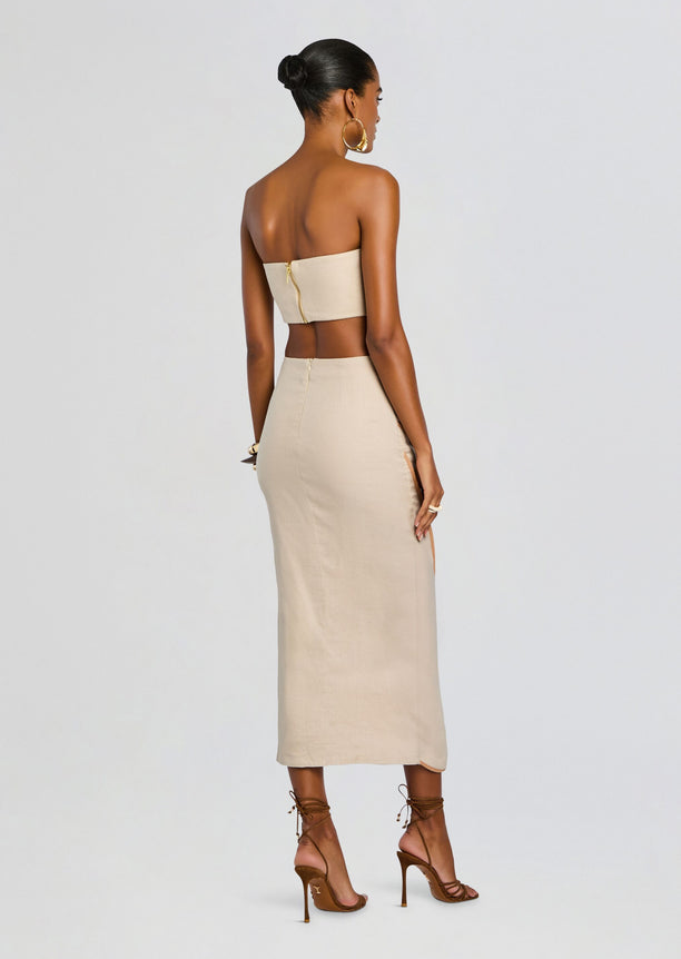 Back view of beige bandeau top and wrap skirt with center back zipper.