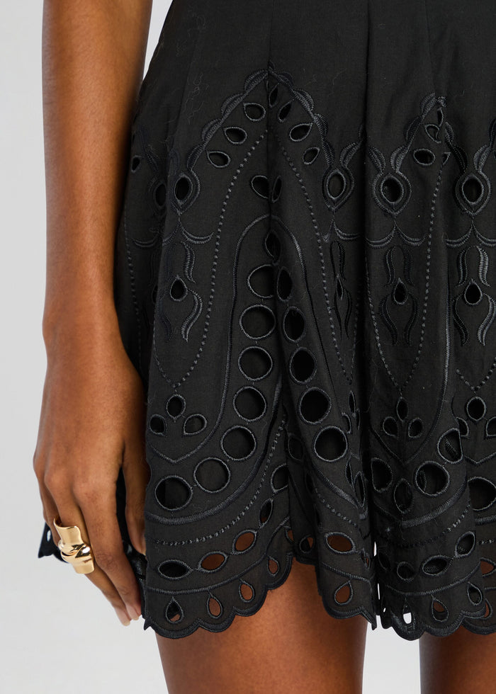 Close-up of the Bail Short Dress showing intricate black eyelet embroidery and a scalloped hem. media 2 of 5