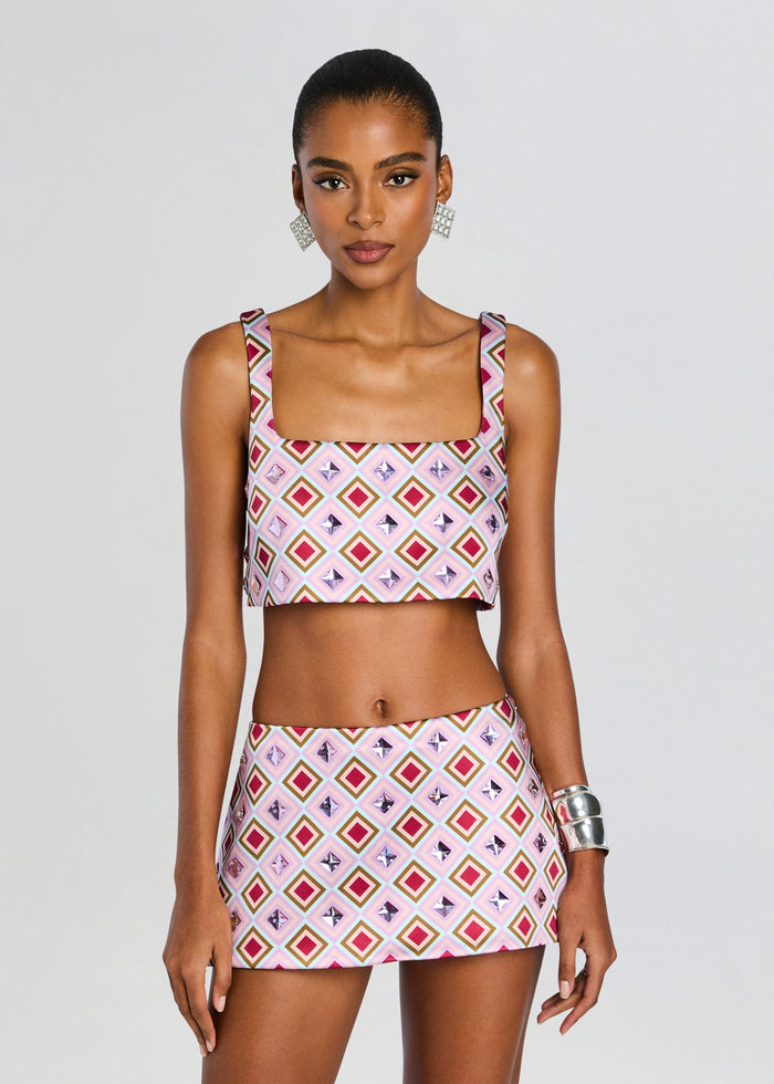 Model wears Thalisa Embellished Top and matching patterned mini skirt in pink geometric print. media 1 of 6