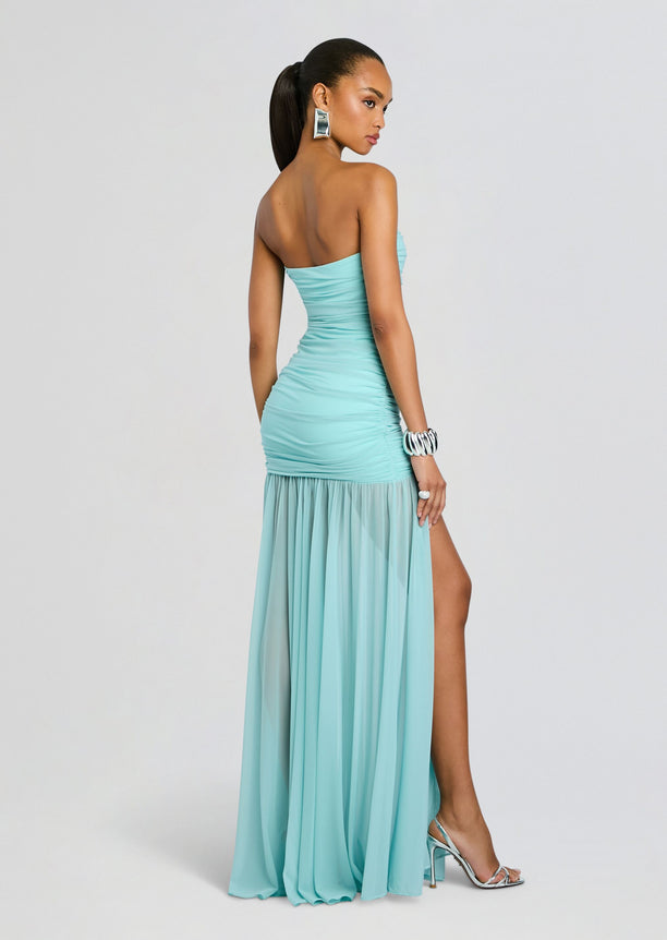 Back view of Adele Dress turquoise strapless gown with ruched bodice and a long sheer skirt with a side slit.